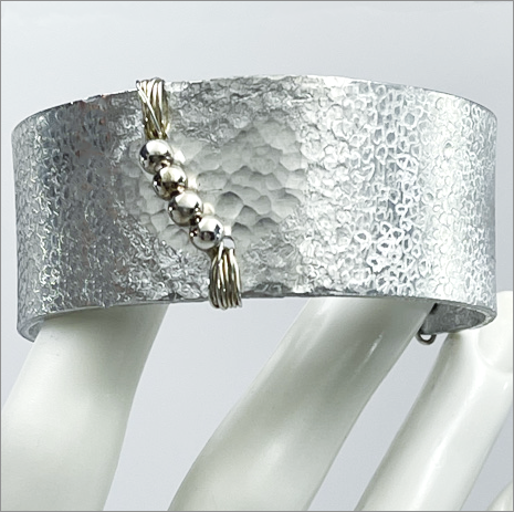 Hand-etched aluminum cuff bracelets created by jewelry artist, Dee Van Houten